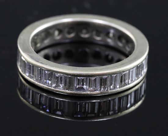 A white gold and baguette cut diamond set full eternity ring, size L.
